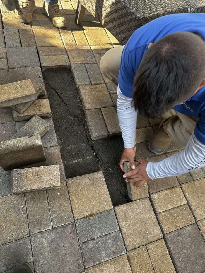 guys working 3 Outdoor kitchen and dining table on a paved patio. Boulder Falls provides custom outdoor kitchen installations in Vancouver WA and Camas WA.